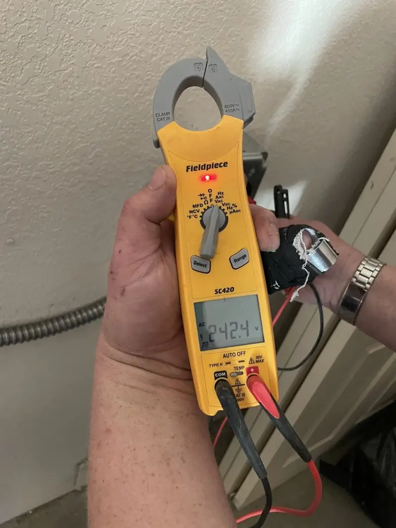 Voltage testing with clamp meter during Recessed Lighting Installation in Cheektowaga